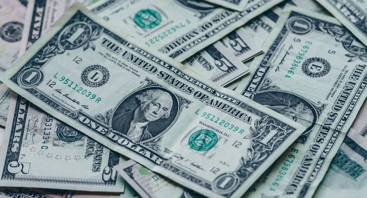 Close-up image of stacked US dollar bills representing wealth and finance.