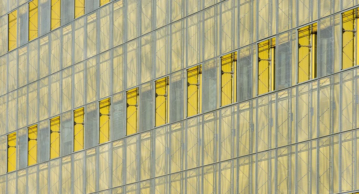 Modern abstract glass facade displaying yellow panels in Zoetermeer.